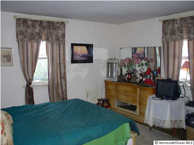 13 Success Road New Egypt, NJ 08533 - Photo 3 of 3 a bed room with a bed mirror and a window