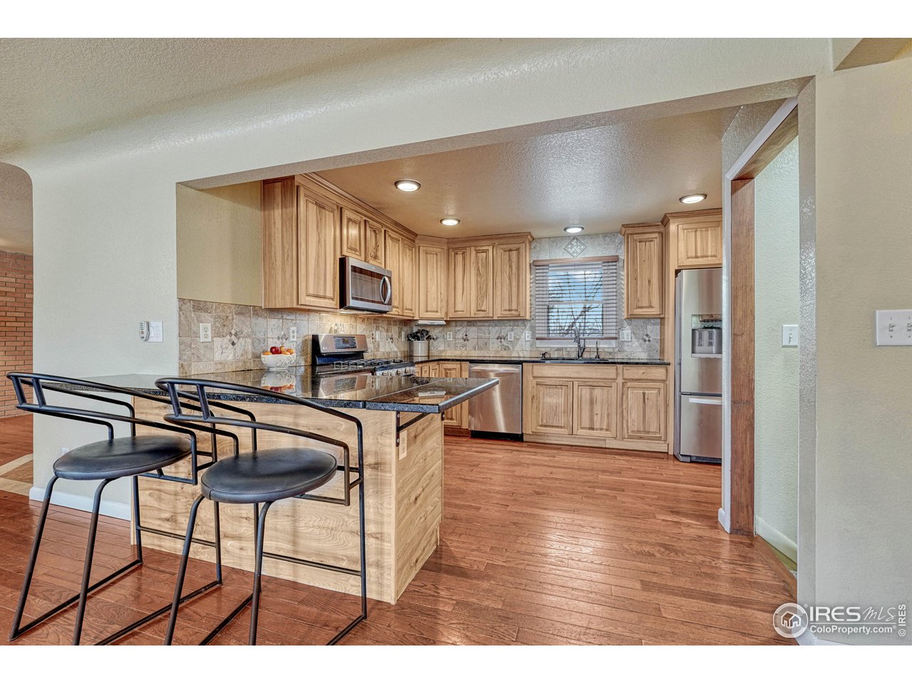 2518 Highland Road Greeley, CO 80634 - Photo 12 of 40 Beautiful surfaces, eat-in breakfast counter between dining area and kitchen.