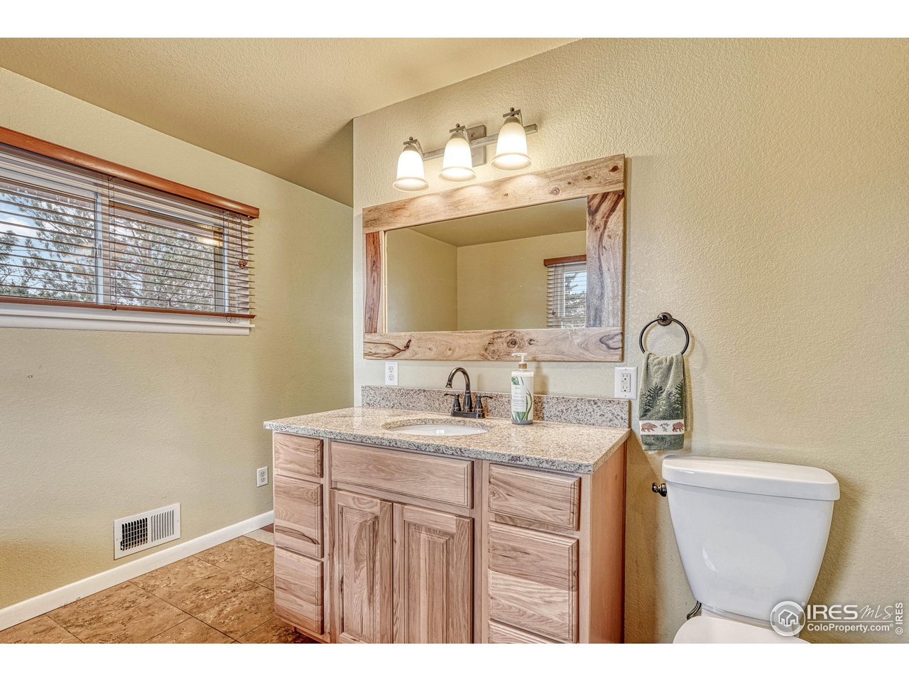 2518 Highland Road Greeley, CO 80634 - Photo 18 of 40 Hickory vanity with granite counter and single sink.