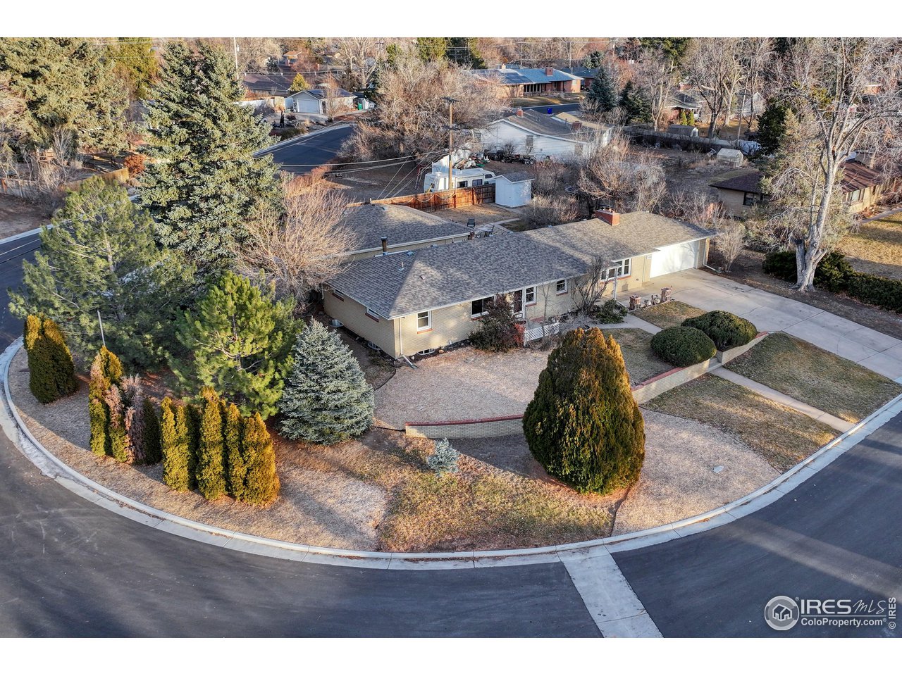Expansive corner lot with mature landscaping and parking galore. Home has new windows throughout and a newer roof.