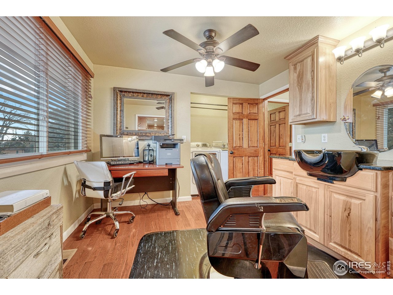 2518 Highland Road Greeley, CO 80634 - Photo 22 of 40 Flex space currently used as beautician space, complete with main level laundry (as well as laundry room on lower level). Seller will leave as is, or replace sink with laundry basin sink if preferred by buyer.