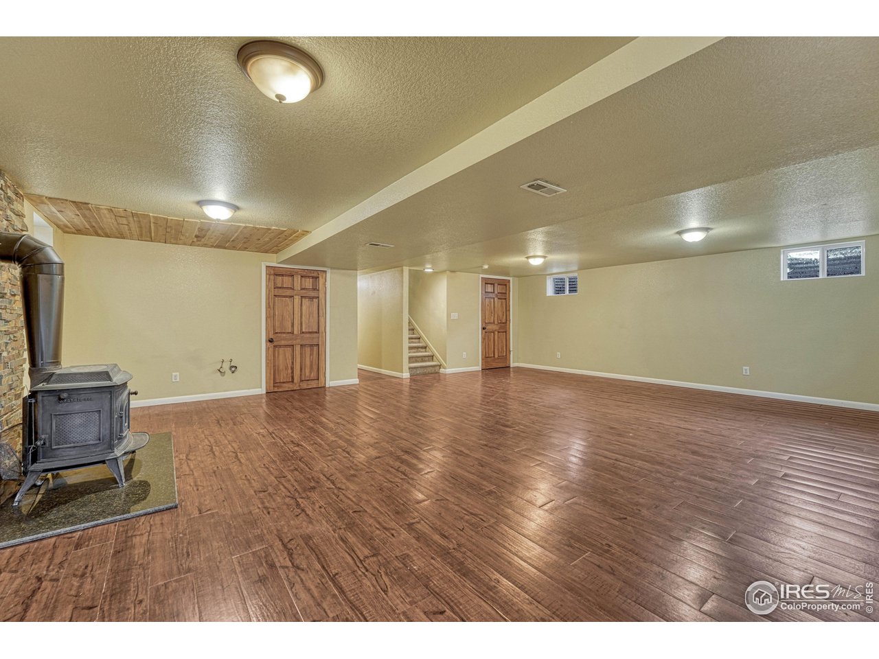 2518 Highland Road Greeley, CO 80634 - Photo 25 of 40 Open and updated basement family area with 2 closets (one has sprinkler system setup and the other is the utility close, both have extra storage space.