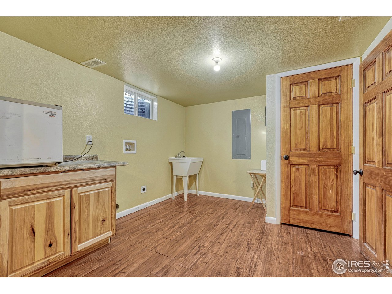 2518 Highland Road Greeley, CO 80634 - Photo 30 of 40 Lower level laundry room with laundry tub sink, cabinetry and closet for additional storage