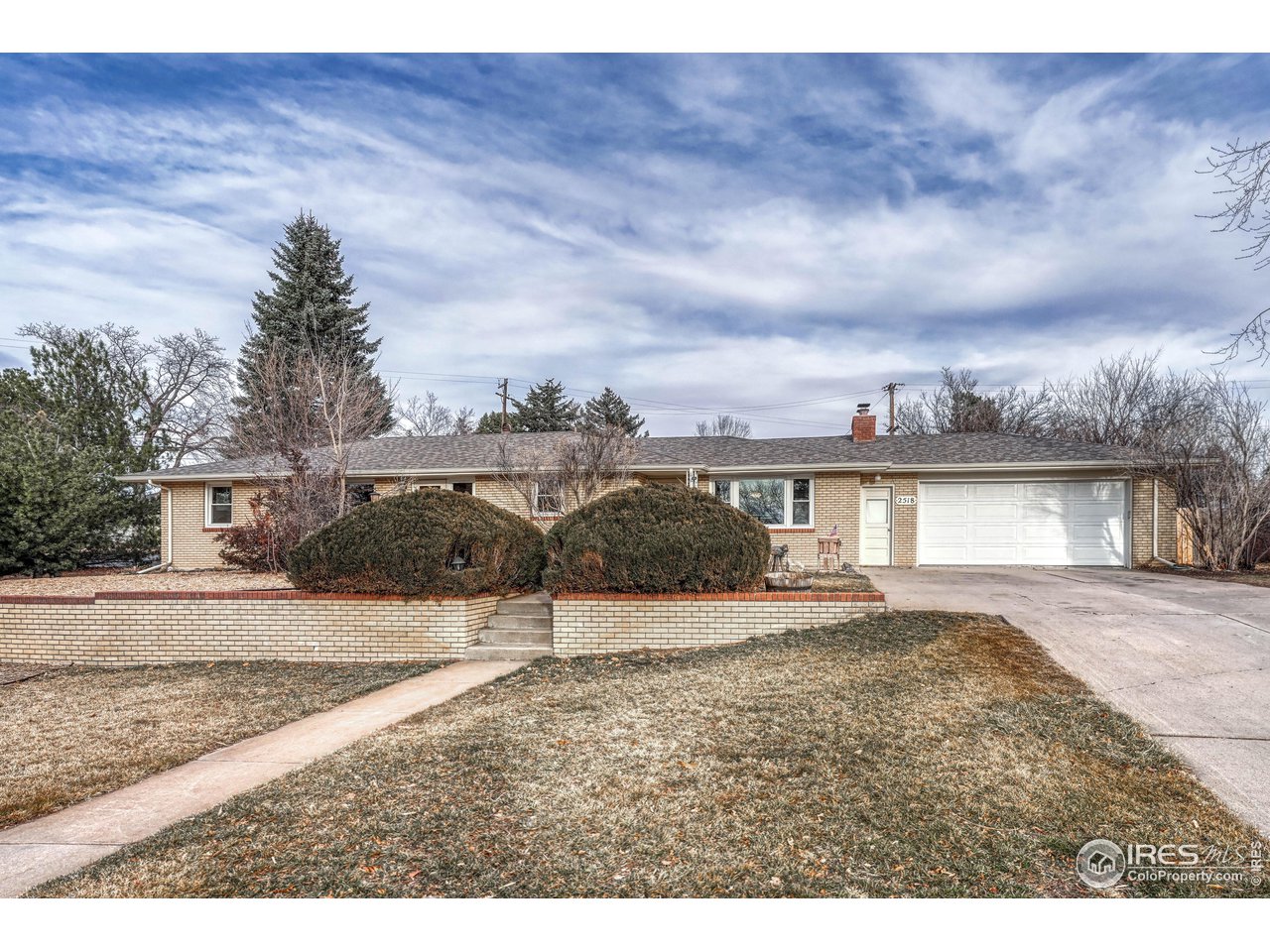 Tiered front yard with retaining wall and sprinkler system.