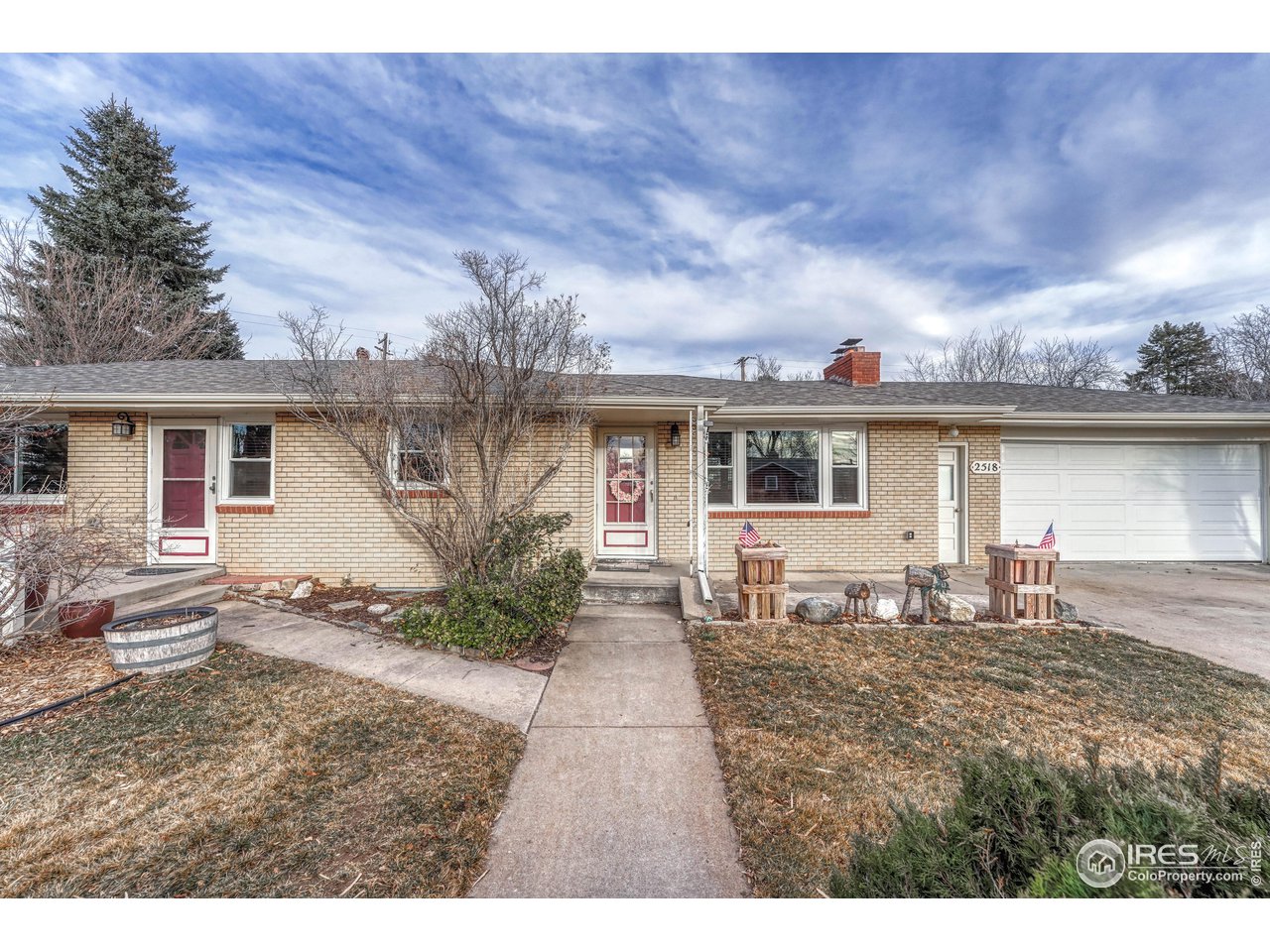 Home offers separate entrance (to the left) that accesses the flex space, currently a beautician setup, or office, mudroom, with main level laundry.
