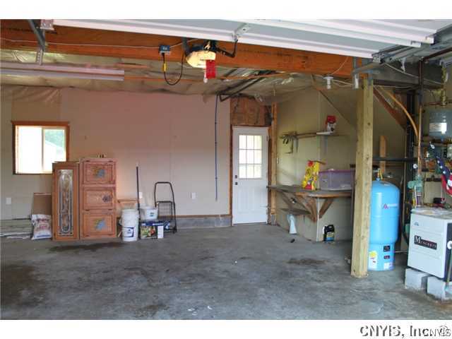 21831 Knowlesville Road Pamelia, NY 13601 - Photo 25 of 25 Garage. Large 2 vehicle garage with work bench. Bo