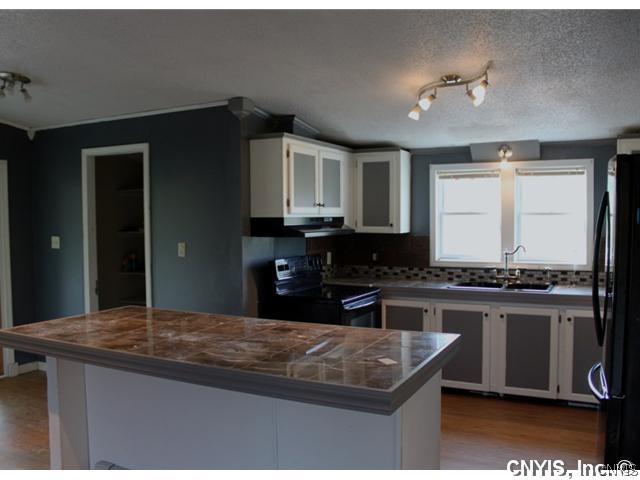 21831 Knowlesville Road Pamelia, NY 13601 - Photo 9 of 25 Exterior Front. Kitchen with granite tile counter