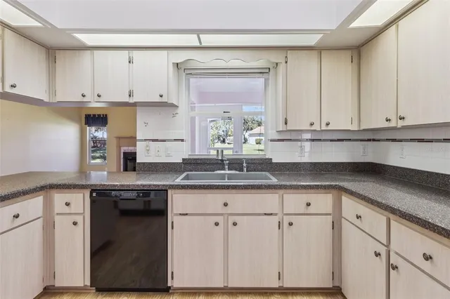 a view of a hallway with a chandelier fan and wooden floor