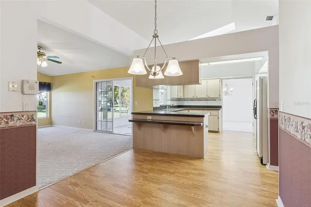 a bathroom with a granite countertop sink a mirror a vanity and a shower