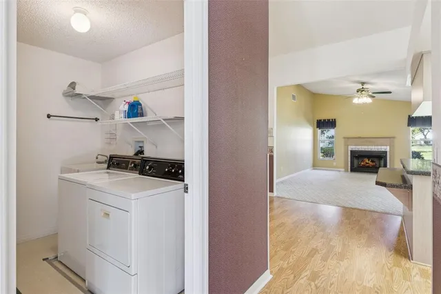 a view of a patio with table and chairs under an umbrella