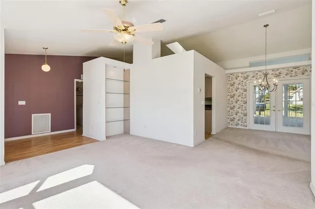 a view of an empty room with a fireplace and a window