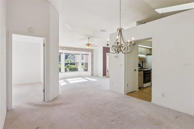 a view of a kitchen with a sink and a refrigerator