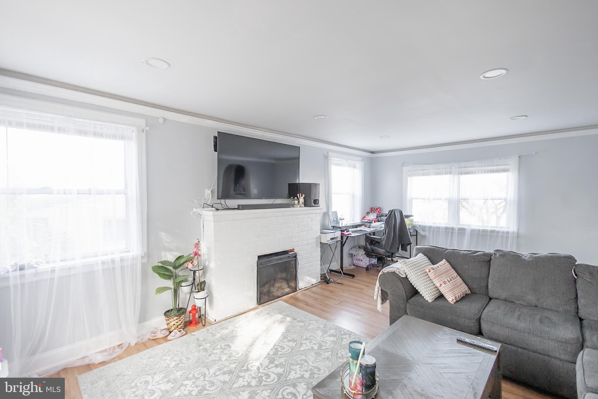 924 West Evesham Road Glendora, NJ 08029 - Photo 12 of 28 a living room with furniture a fireplace and a flat screen tv
