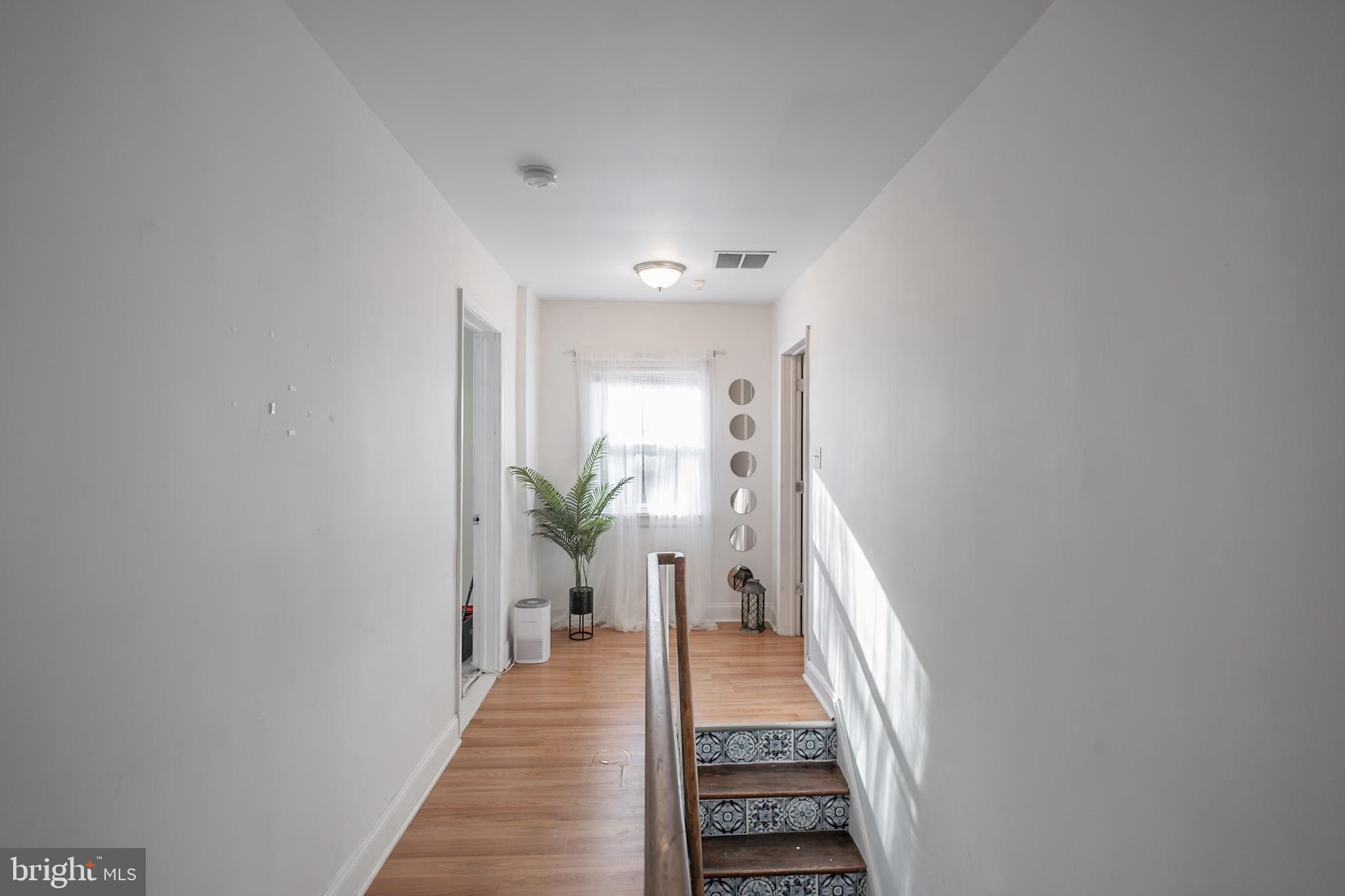 924 West Evesham Road Glendora, NJ 08029 - Photo 23 of 28 a view of a hallway with wooden floor and a potted plant