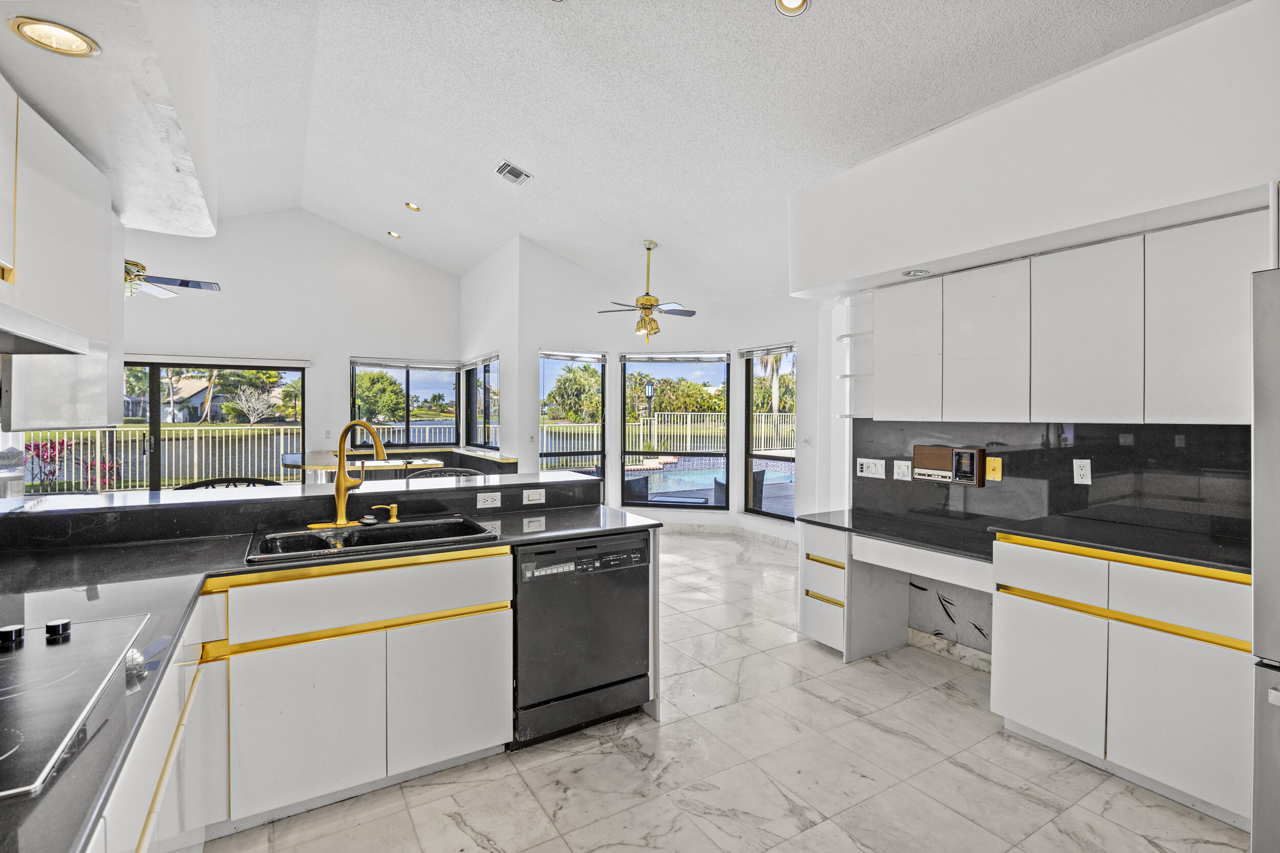 10747 Stonebridge Boulevard Boca Raton, FL 33498 - Photo 18 of 75 a kitchen with stainless steel appliances a sink stove and cabinets