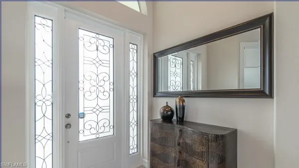 a view of a door with wooden floor and windows