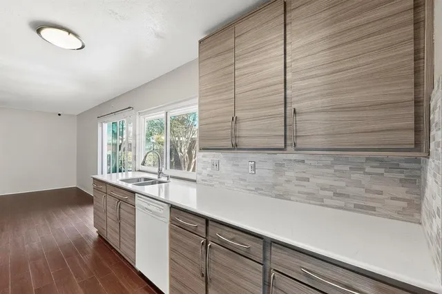 a kitchen with a refrigerator stove and a sink