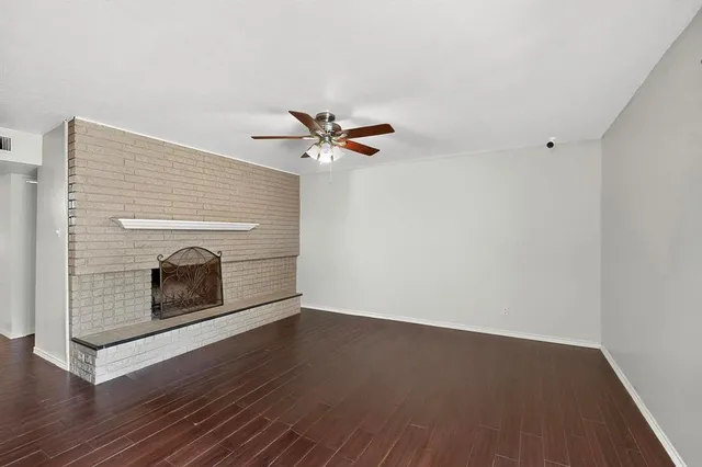 a view of a living room hardwood floor and a ceiling fan