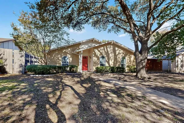 a view of a house with a yard and tree s