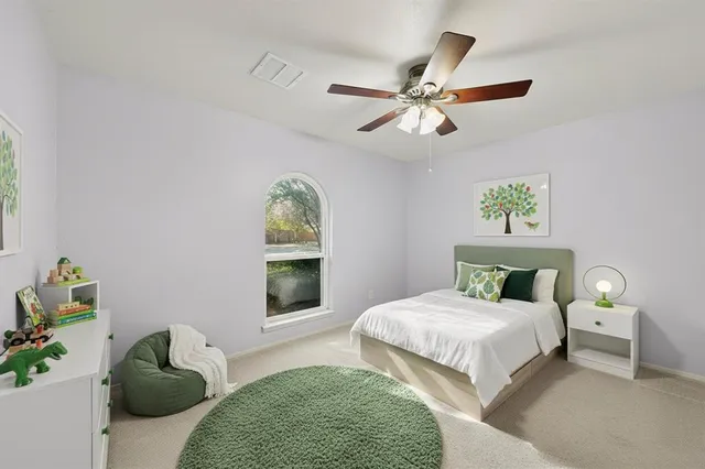 an empty room with windows and ceiling fan