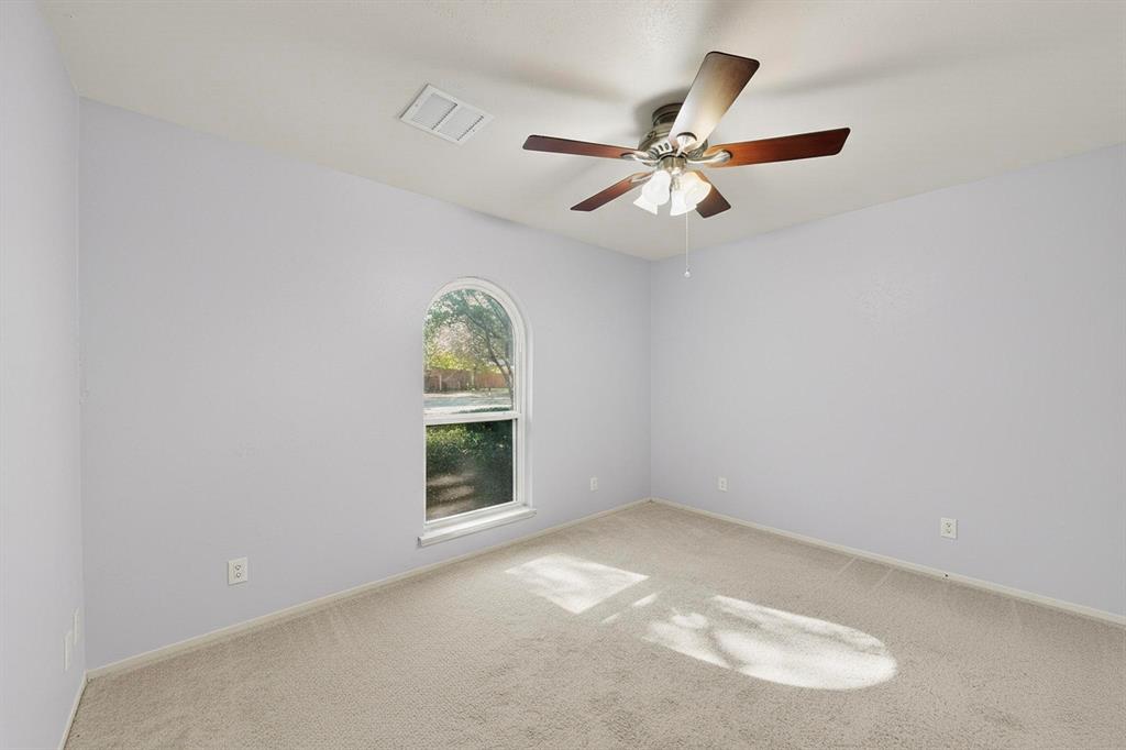 913 Overdowns Drive Plano, TX 75023 - Photo 22 of 35 an empty room with windows and ceiling fan