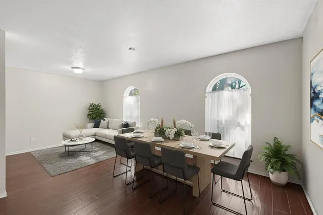 an empty room with wooden floor and window