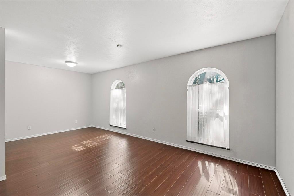 913 Overdowns Drive Plano, TX 75023 - Photo 6 of 35 an empty room with wooden floor and window