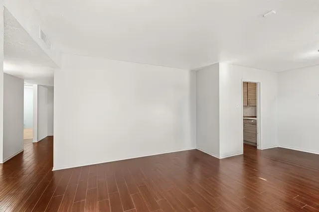 a kitchen with granite countertop a sink a counter space appliances and cabinets
