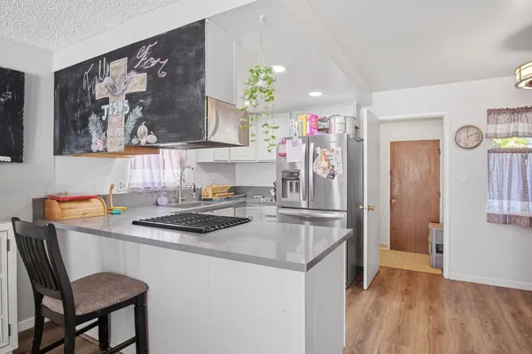 a kitchen that has a sink and a stove in it
