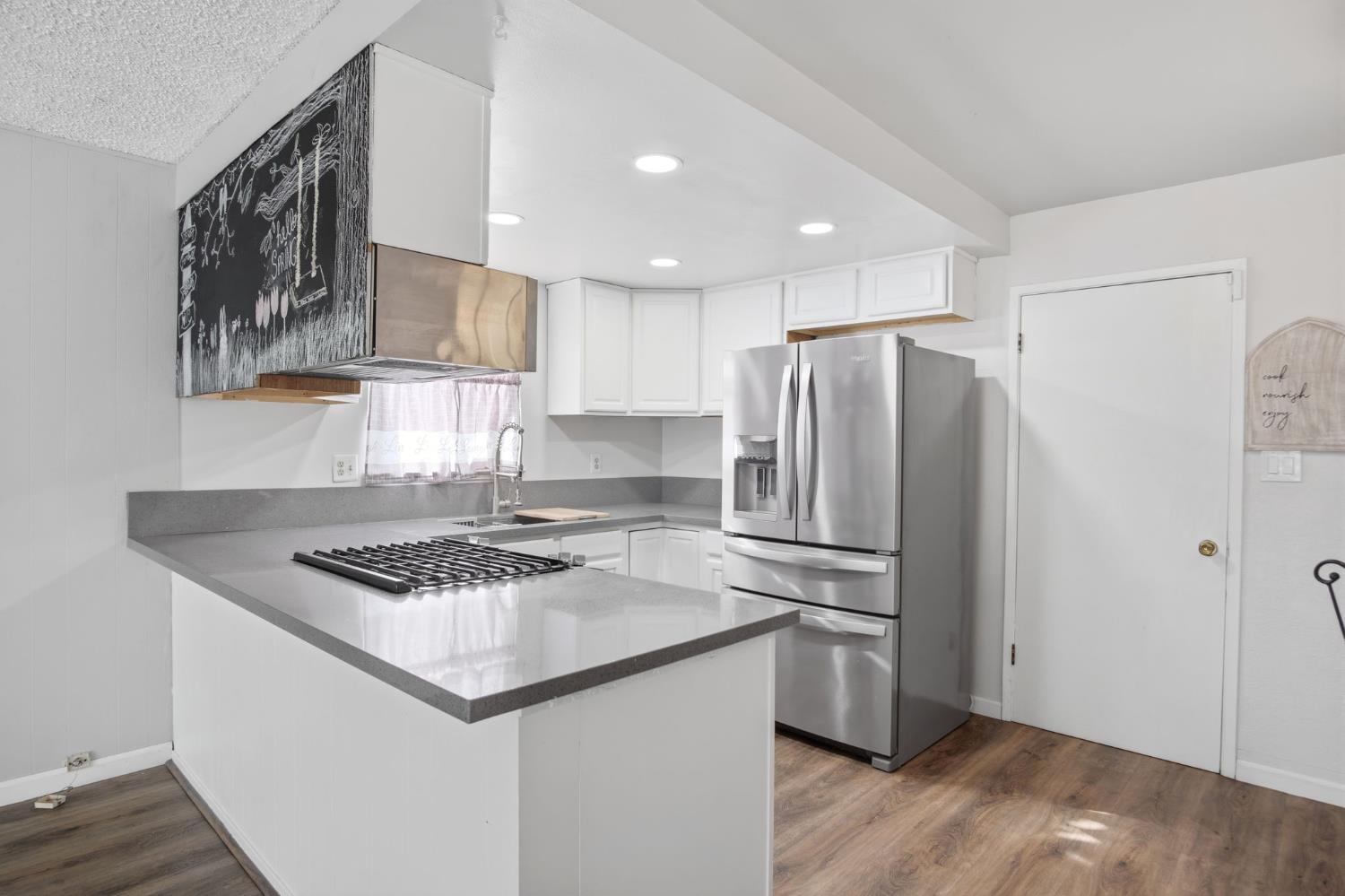 1436 Montclair Drive Modesto, CA 95350 - Photo 13 of 29 a kitchen with a refrigerator and a sink