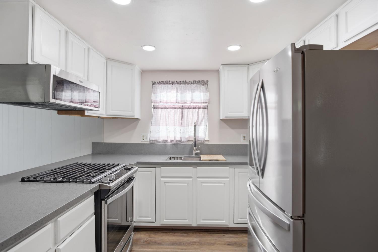 1436 Montclair Drive Modesto, CA 95350 - Photo 15 of 29 a kitchen with stainless steel appliances granite countertop a refrigerator sink and microwave