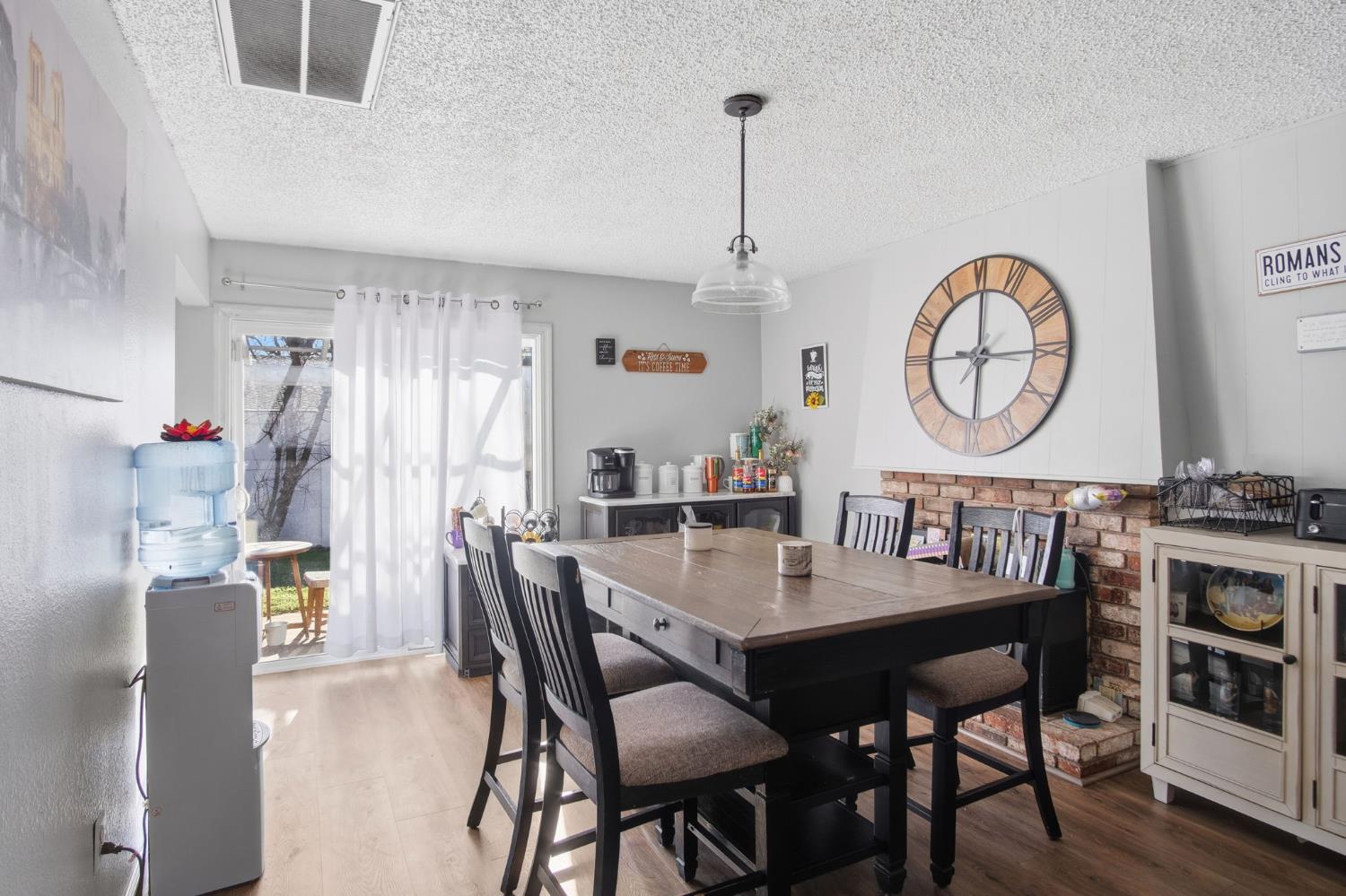 1436 Montclair Drive Modesto, CA 95350 - Photo 16 of 24 a view of a dining room and livingroom with furniture wooden floor a chandelier