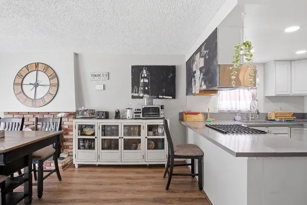 a kitchen with a cabinets a sink and a stove with wooden floor