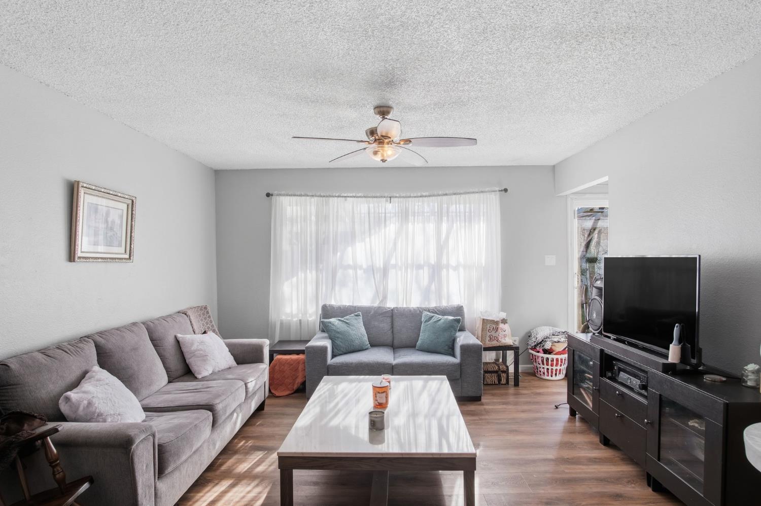 1436 Montclair Drive Modesto, CA 95350 - Photo 19 of 24 a living room with furniture and a flat screen tv