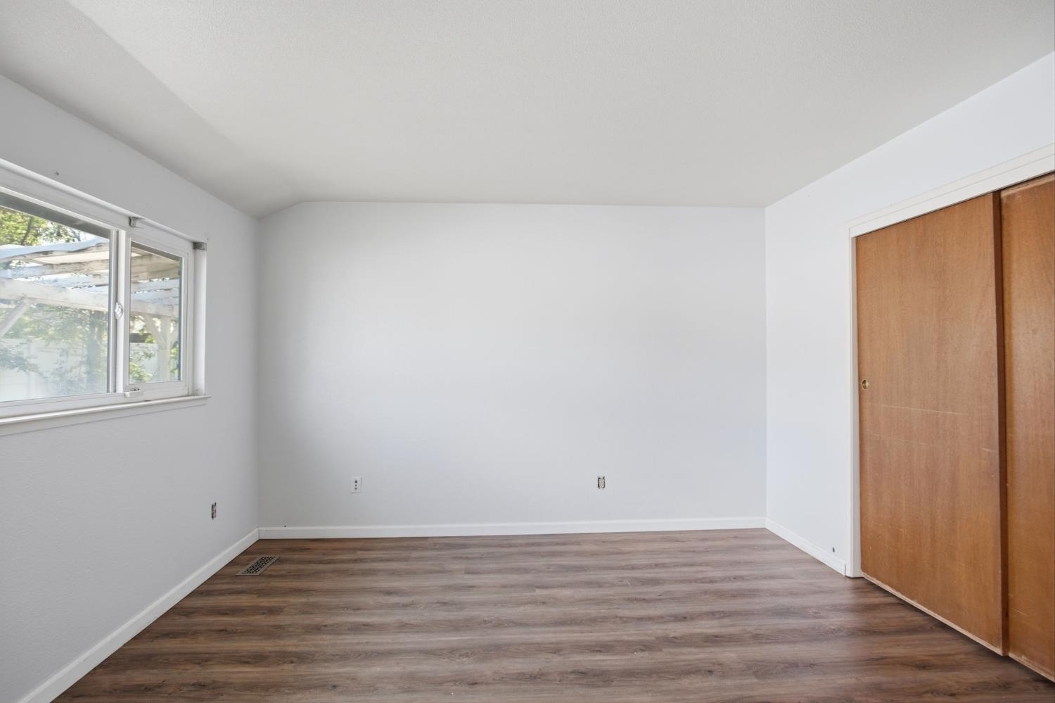 1436 Montclair Drive Modesto, CA 95350 - Photo 24 of 29 a view of an empty room with wooden floor and a window