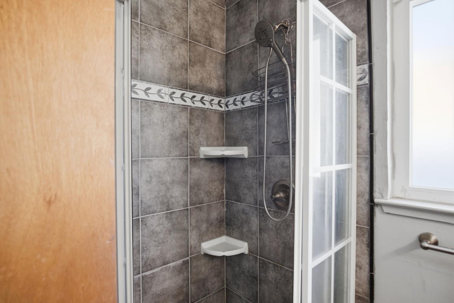 1436 Montclair Drive Modesto, CA 95350 - Photo 26 of 29 a bathroom with a glass shower door