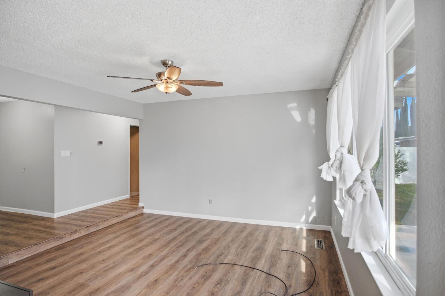 1436 Montclair Drive Modesto, CA 95350 - Photo 8 of 29 wooden floor in an empty room with a window
