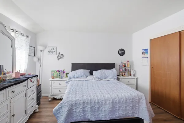 a bedroom with a bed and a dresser