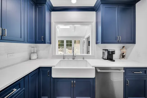 a kitchen with a sink cabinets and window