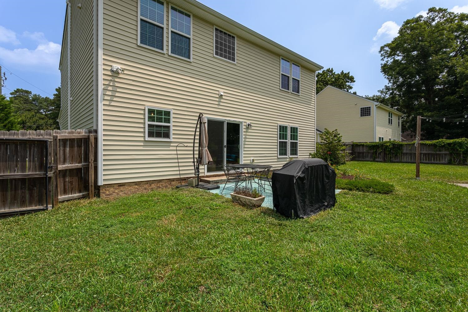 322 Forest Lane Wendell, NC 27591 - Photo 14 of 37 a backyard of a house with barbeque oven and wooden fence