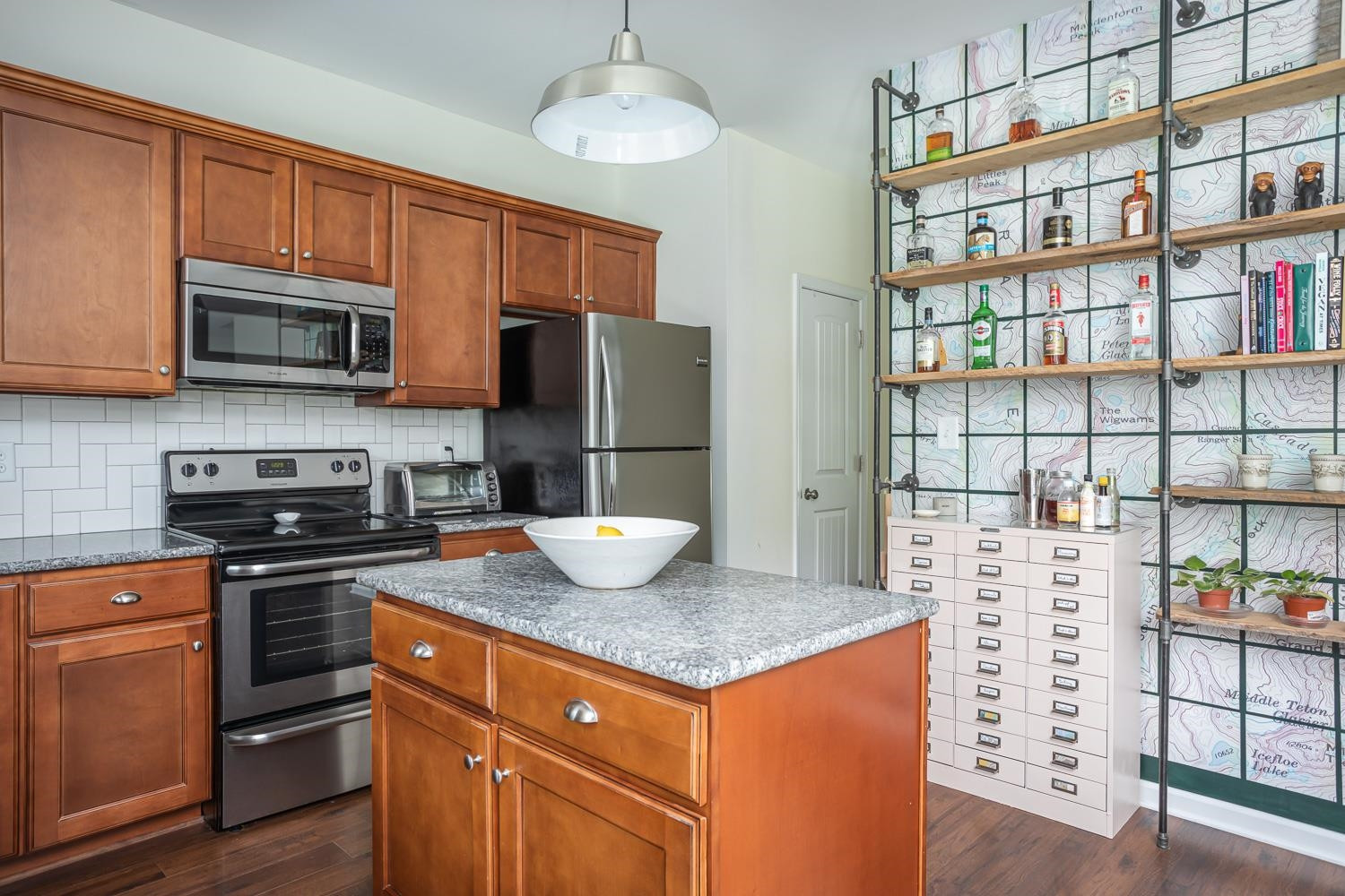 322 Forest Lane Wendell, NC 27591 - Photo 23 of 37 a kitchen with stainless steel appliances kitchen island granite countertop a refrigerator a stove top oven a sink and cabinets