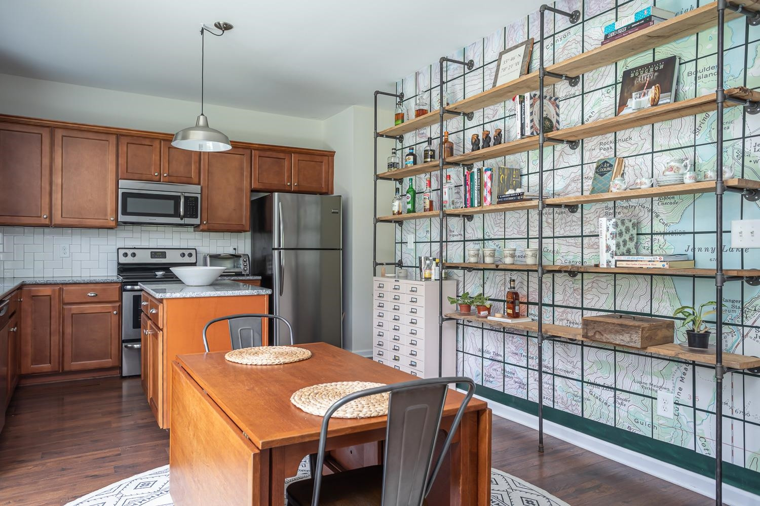 322 Forest Lane Wendell, NC 27591 - Photo 24 of 37 a kitchen with stainless steel appliances granite countertop a stove a refrigerator a sink dishwasher a dining table and chairs with wooden floor