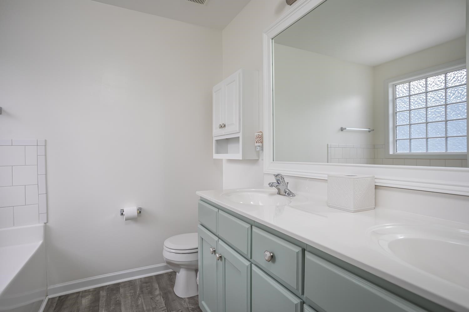 322 Forest Lane Wendell, NC 27591 - Photo 35 of 37 a bathroom with a toilet a sink a mirror and a window