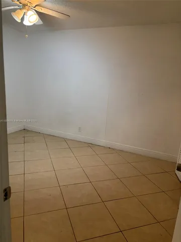 a view of a room with an empty space and a window