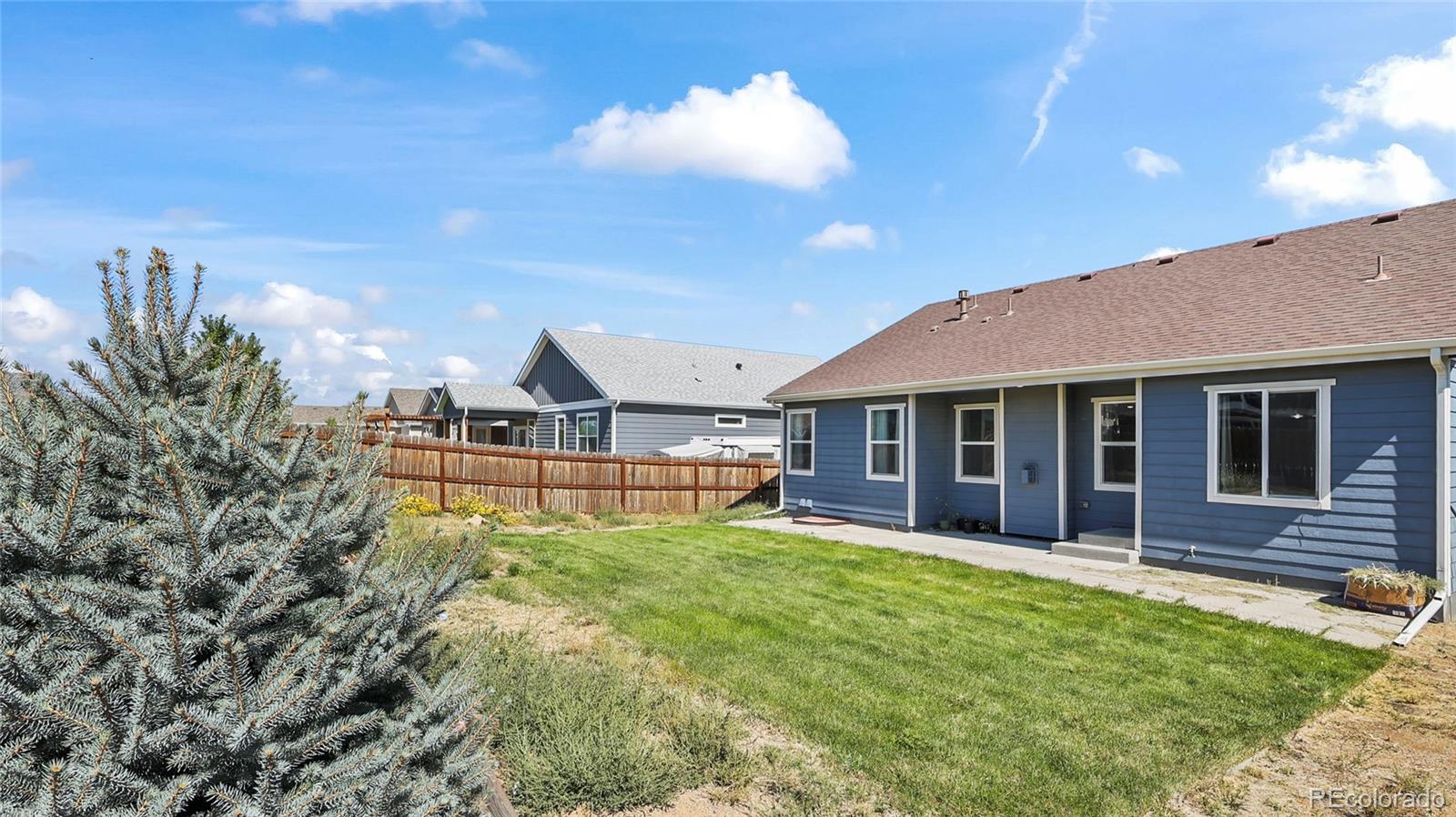 1106 Johnson Street Wiggins, CO 80654 - Photo 20 of 22 a view of a house with a yard porch and sitting area