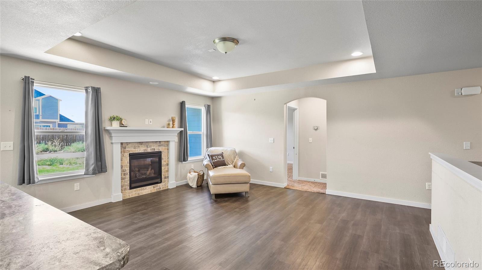 1106 Johnson Street Wiggins, CO 80654 - Photo 5 of 22 a living room with furniture and a fireplace