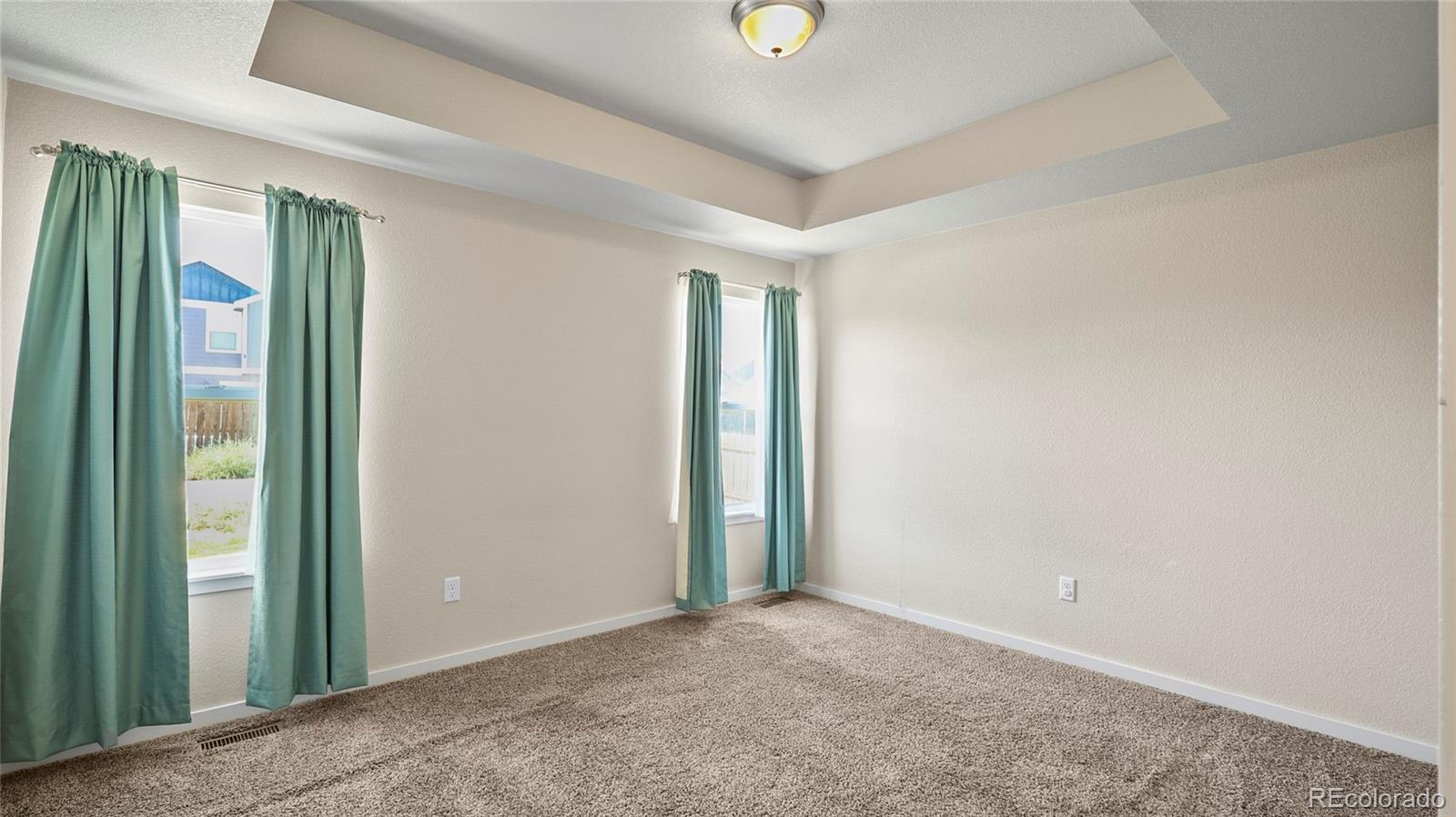 1106 Johnson Street Wiggins, CO 80654 - Photo 6 of 22 an empty room with windows and closet