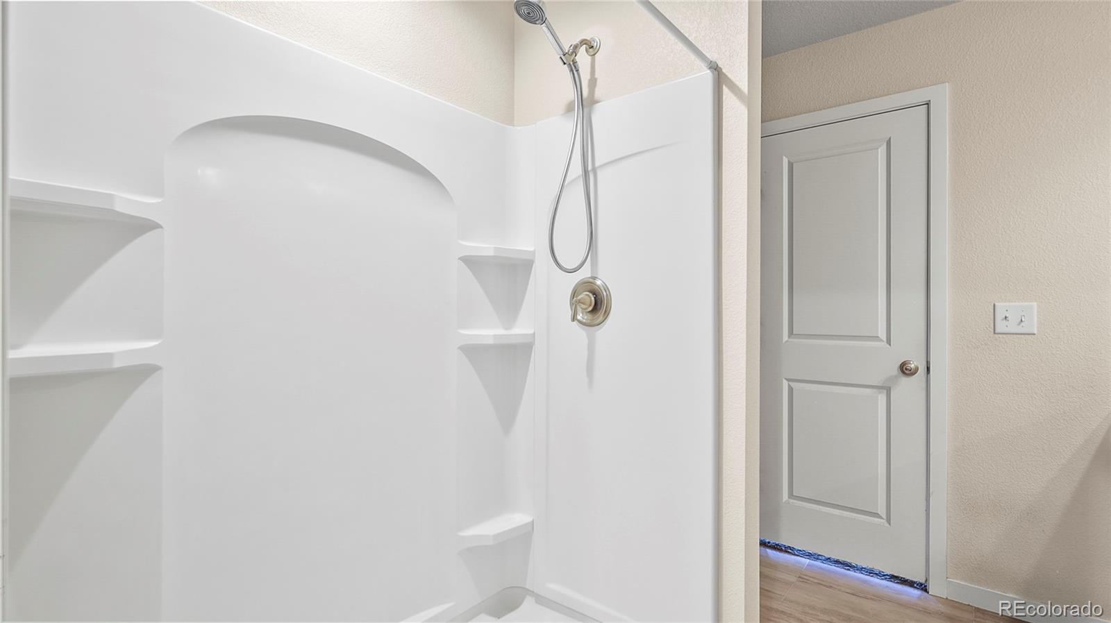 1106 Johnson Street Wiggins, CO 80654 - Photo 9 of 22 a bathroom with a shower