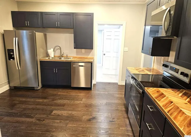 a kitchen with stainless steel appliances a refrigerator and a stove