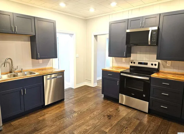 a kitchen with stainless steel appliances granite countertop a stove and a refrigerator